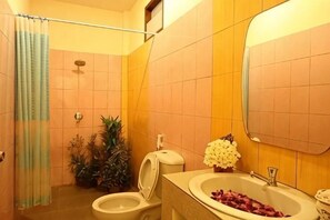A bathroom with a shower, toilet, sink, and mirror. - Sawaddee Aonang Resort (Krabi)