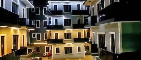 A multi-story residential building with balconies and a central courtyard.