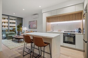 Stovetop, electric kettle, coffee grinder, cookware/dishes/utensils