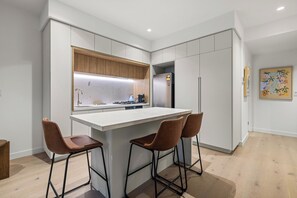 Stovetop, electric kettle, coffee grinder, cookware/dishes/utensils