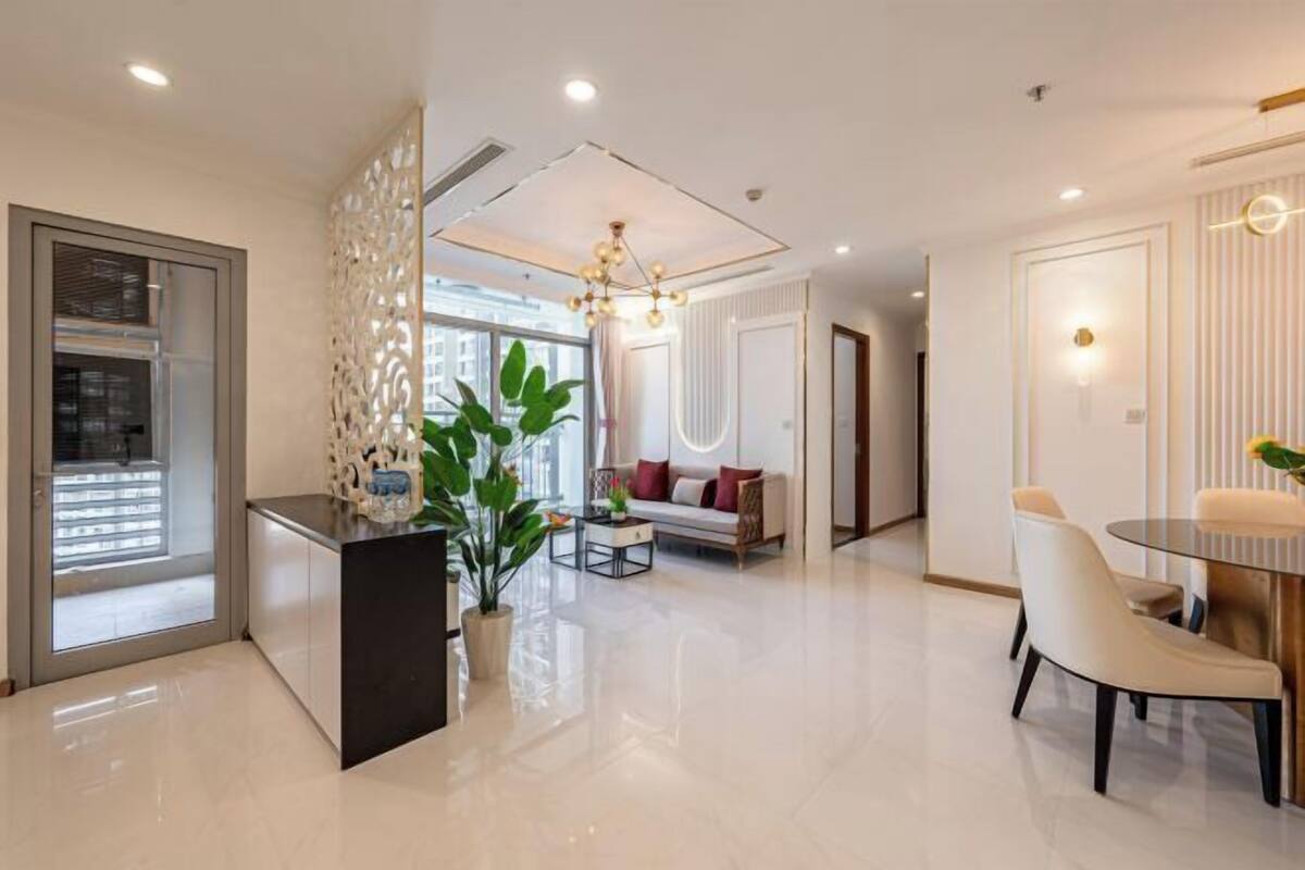 A modern living room with a sofa, coffee table, and decorative plants.