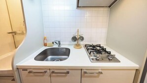 A kitchen with a sink, stove, and cabinets. - EST Swan's City Shinsaibashi East Shimanouchi (Osaka)
