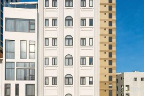 A multi-story building with a series of balconies and windows.