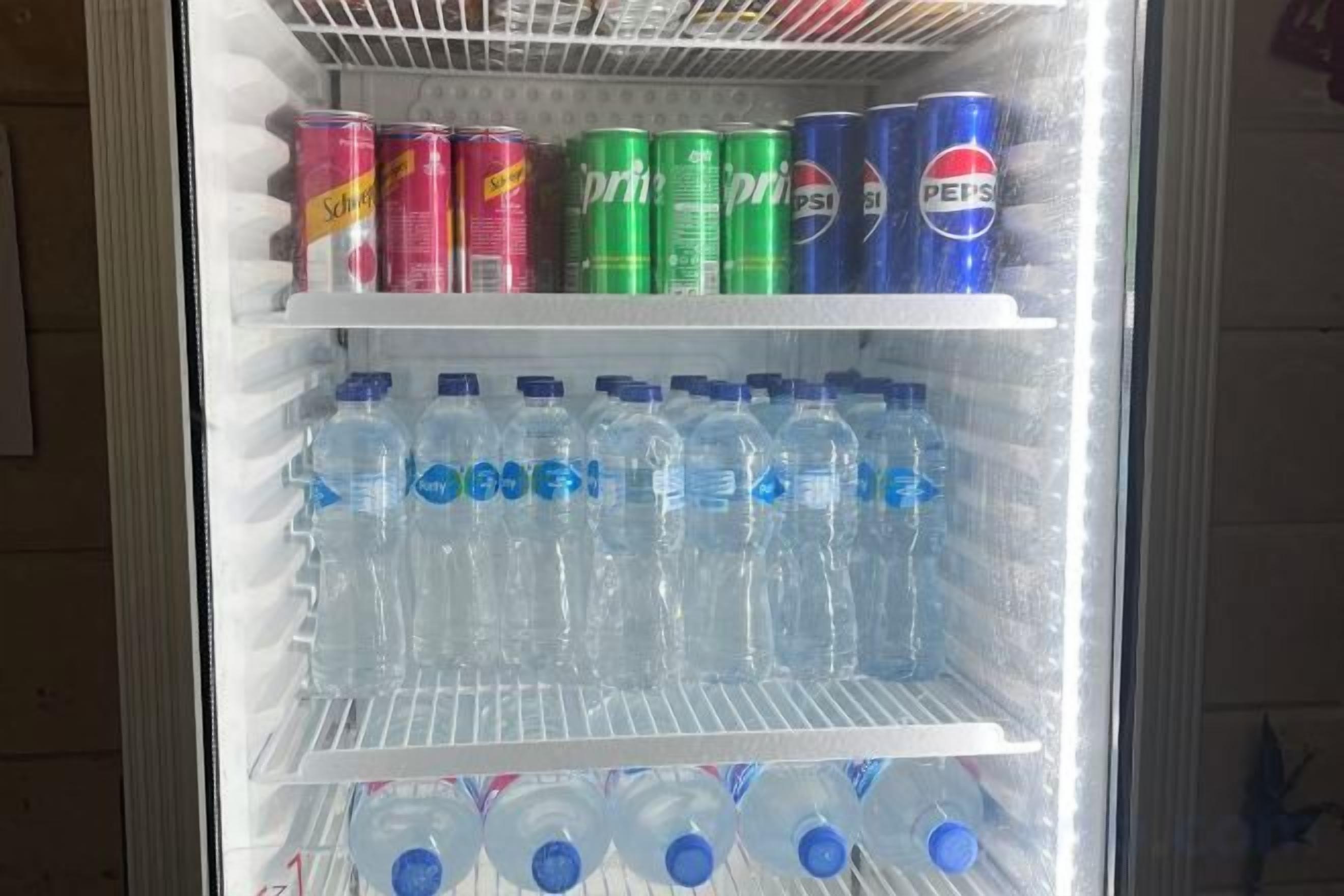A vending machine with various beverage cans and bottles.