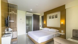 A modern hotel room with a large bed, a desk, a chair, and a TV. - Petchsiri Boutique Hotel (Bangkok)