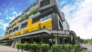 A multi-story building with balconies, a signboard, and a contact number. - Petchsiri Boutique Hotel (Bangkok)