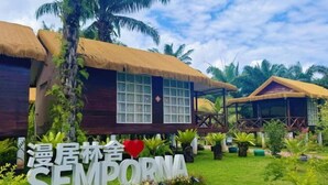 A thatched-roof building with a large window and a sign reading "Sempora". - MANJU SEMPORNA RESORT (Semporna)