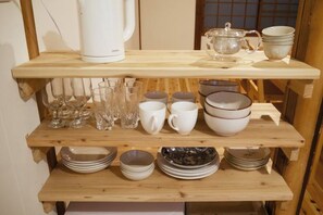 A wooden shelf with various glassware, white cups, and bowls. - PIER & JETTY - Shiratori 2 (Osaka)
