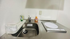 A stainless steel sink with a soap dispenser, a toothbrush holder, and a weighing scale. - Rest Collection Fushimi-Inari Kyoto (Kyoto)