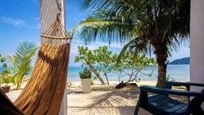 A hammock, a chair, and a view of the beach and ocean. - Coral Reef Holidays (Tioman)