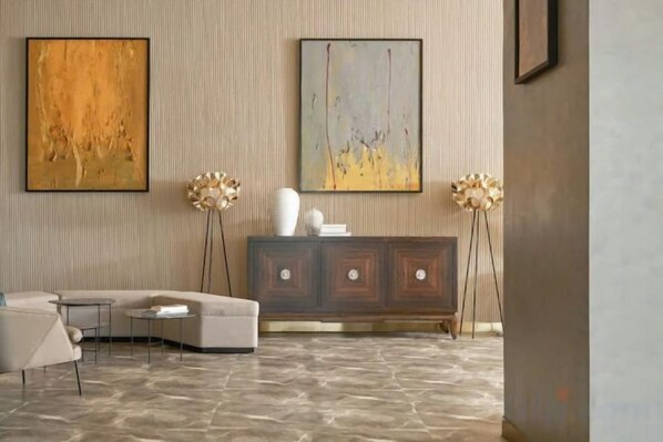 A modern living room with a sofa, a cabinet, and two floor lamps. - Panorama Horizon Inn Nha Trang (Nha Trang)