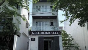 A two-story building with a sign reading 'NIKI HOMESTAY' and a number '01' indicating the unit. - Niki Homestay (Hue)