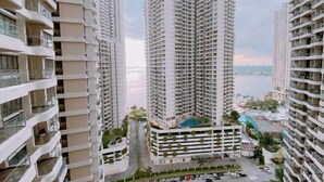 A high-rise residential building with multiple balconies, a swimming pool, and a view of a body of water. - Seafront Country Garden Danga Bay by Lions Bay (Johor Bahru)