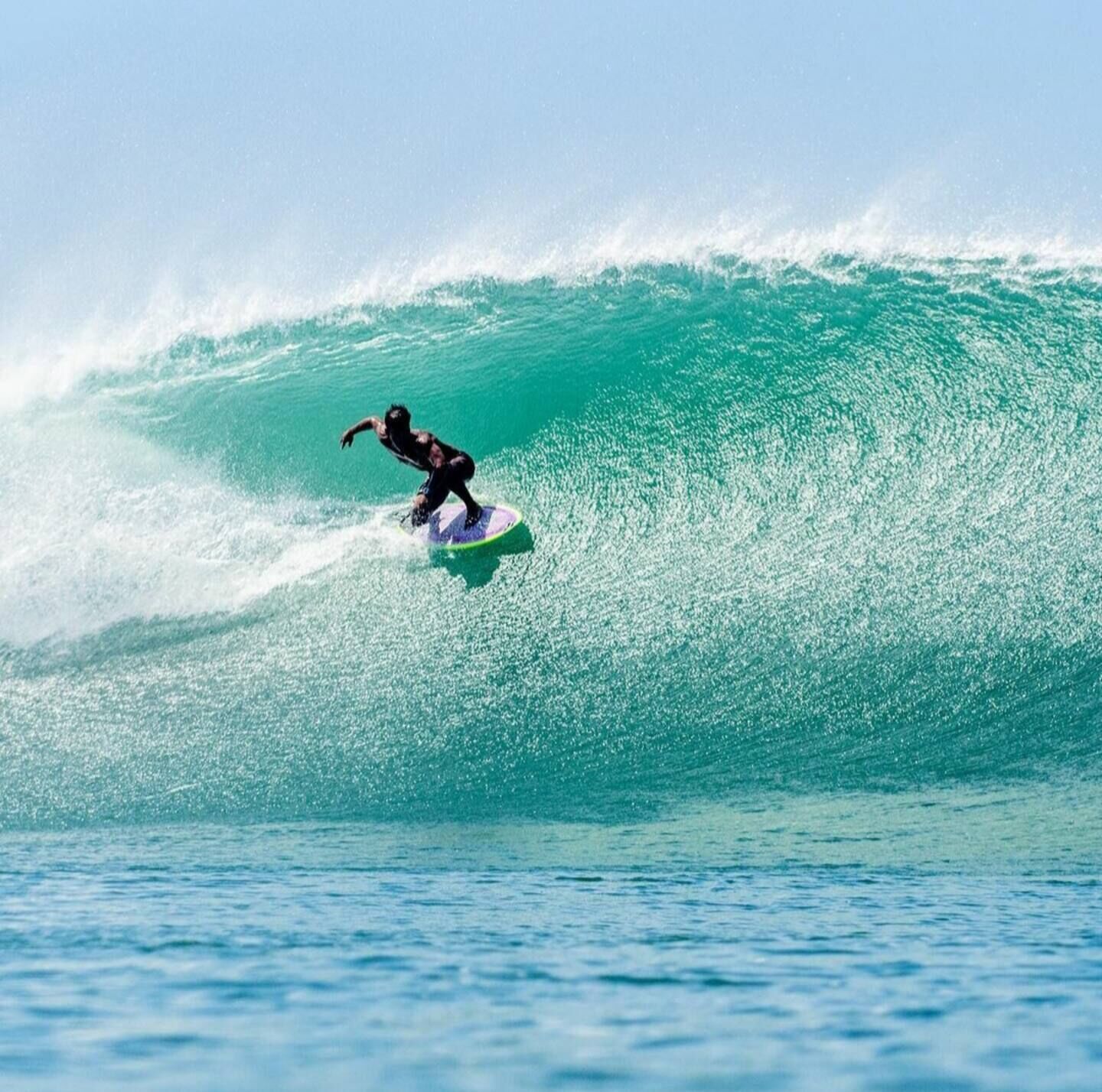A surfer riding a large wave.