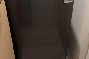 A room with a large window, a door, and a wall with a barcode. - Entire apartment in Higashi Shinjuku (Tokyo)