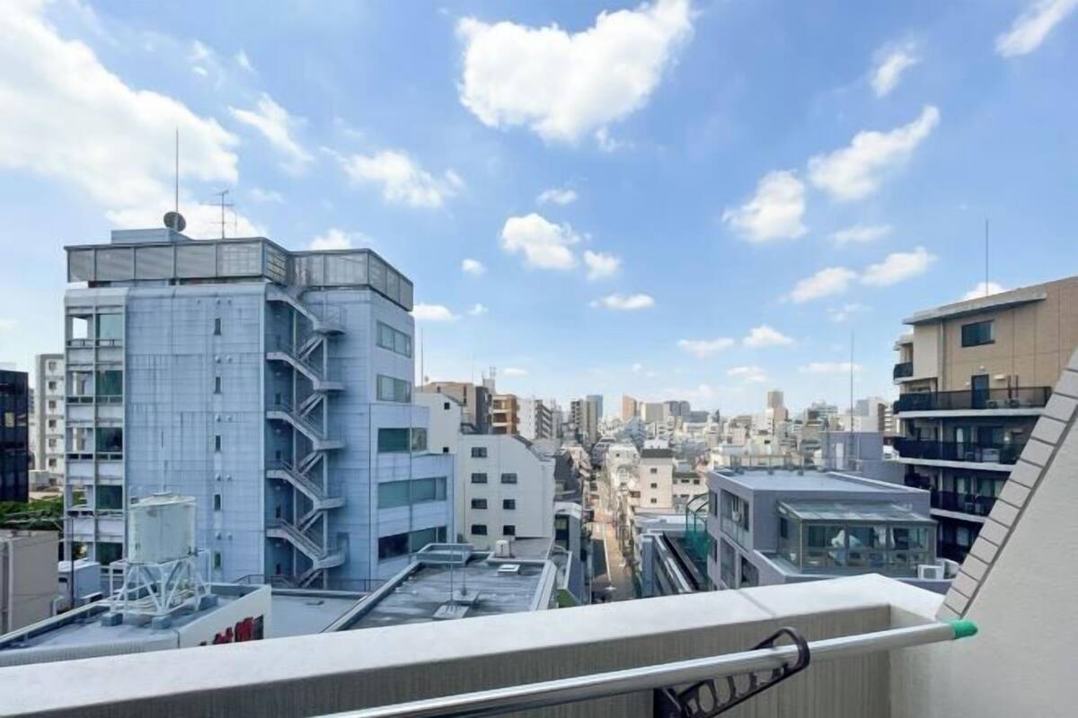 A cityscape with modern buildings, a clear sky, and a view of the urban environment.