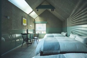 A bedroom with a sloped ceiling, a bed, a desk, and a window. - At Hotel ORTO (Fukuoka)