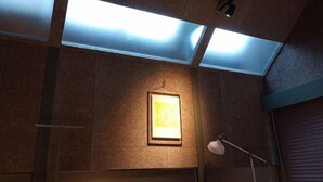 A room with skylights, a framed picture, and a desk lamp. - At Hotel ORTO (Fukuoka)