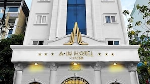 The exterior of A-In Hotel in Vietnam, featuring a prominent entrance with a decorative arch and illuminated signage. - A In Hotel Atistar (Ho Chi Minh City)