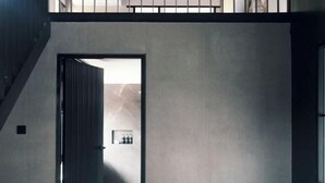 Un interior moderno con una escalera que lleva a un balcón.