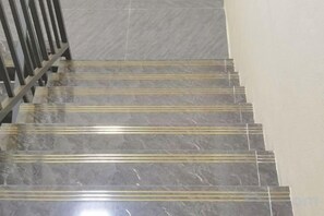 A set of marble stairs with golden stripes, leading to a higher floor. - Happy Hotel (Vientiane)