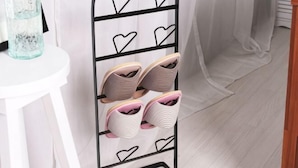 A shoe rack with multiple pairs of shoes, a white table with a glass container, and a white curtain. - Seoul Dajeong House/Hongdae Entrance Sta.Exit7. Party room. Lovely Big House (Seoul)