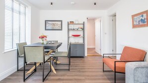 A modern dining area with a table, chairs, and a bookshelf. - 1 Leiston Court, Leiston (Leiston)