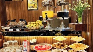 A buffet with various food items, including fruits, pastries, and beverages. - RosaMay Thu Khoa Huan (Ho Chi Minh City)