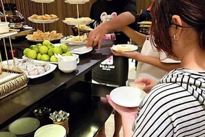 A buffet setup with various food items and a beverage dispenser. - RosaMay Thu Khoa Huan (Ho Chi Minh City)