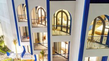 A multi-level hotel atrium with balconies and arched windows.