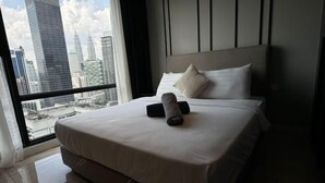 A hotel room with a large bed, a view of city skyscrapers, and a modern design. - Axon Residence Kuala Lumpur KLCC Pavillion BB (Kuala Lumpur)