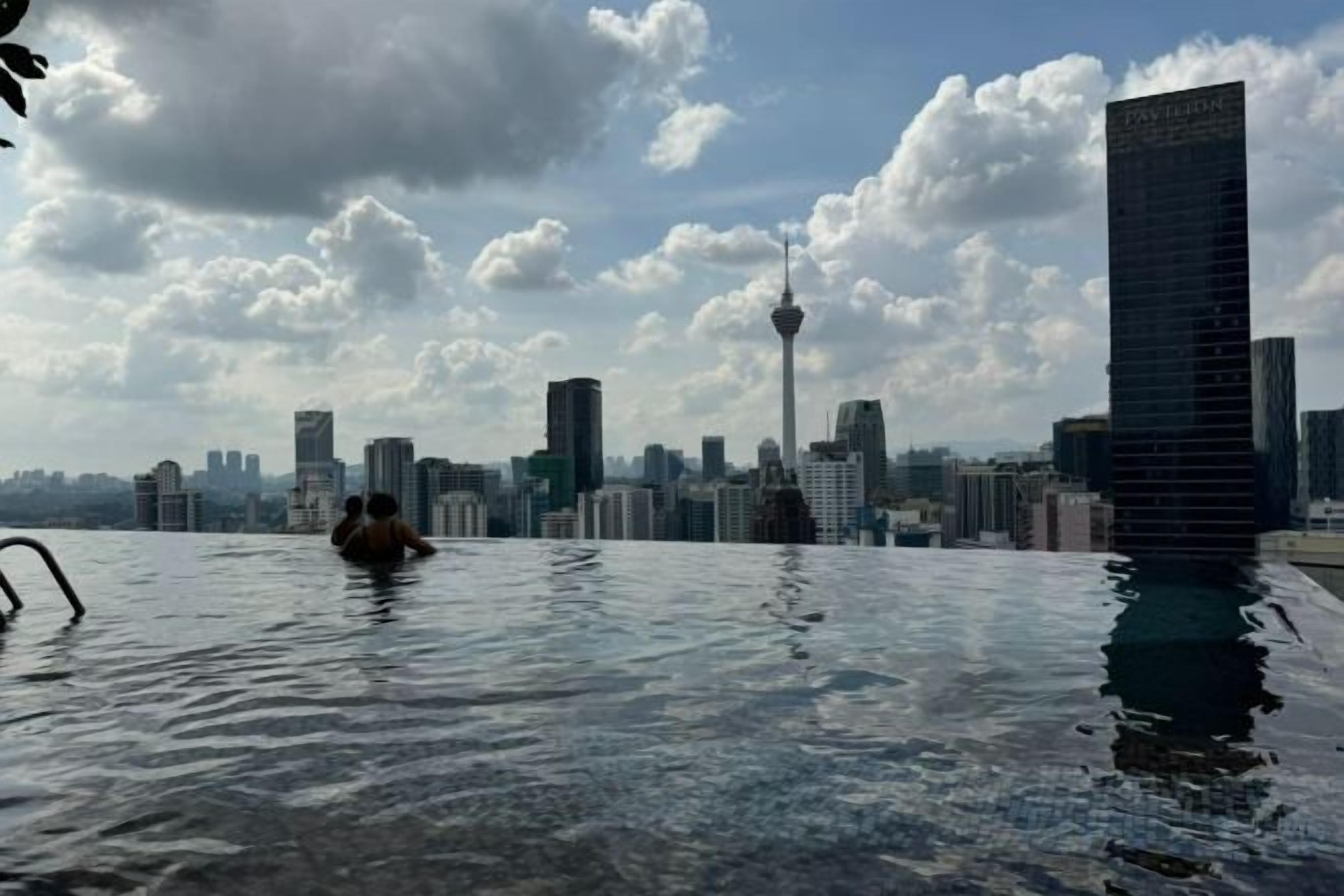 A pool with a city skyline in the background.