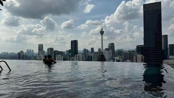 A pool with a city skyline in the background.