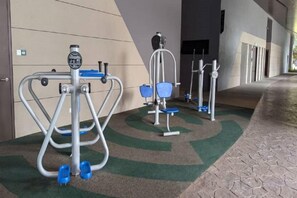Outdoor exercise equipment, including a stepper and a stationary bike, on a patterned carpet. - Axon Residence Kuala Lumpur KLCC Pavillion BB (Kuala Lumpur)