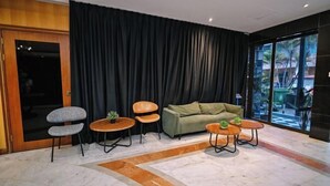 A modern living room with a sofa, two armchairs, and two small tables with plants. - Kingston Hotel 6 @ Changkat Bukit Bintang (Kuala Lumpur)
