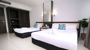 A hotel room with two beds, a large mirror, a wardrobe, and a potted plant. - Kingston Hotel 6 @ Changkat Bukit Bintang (Kuala Lumpur)