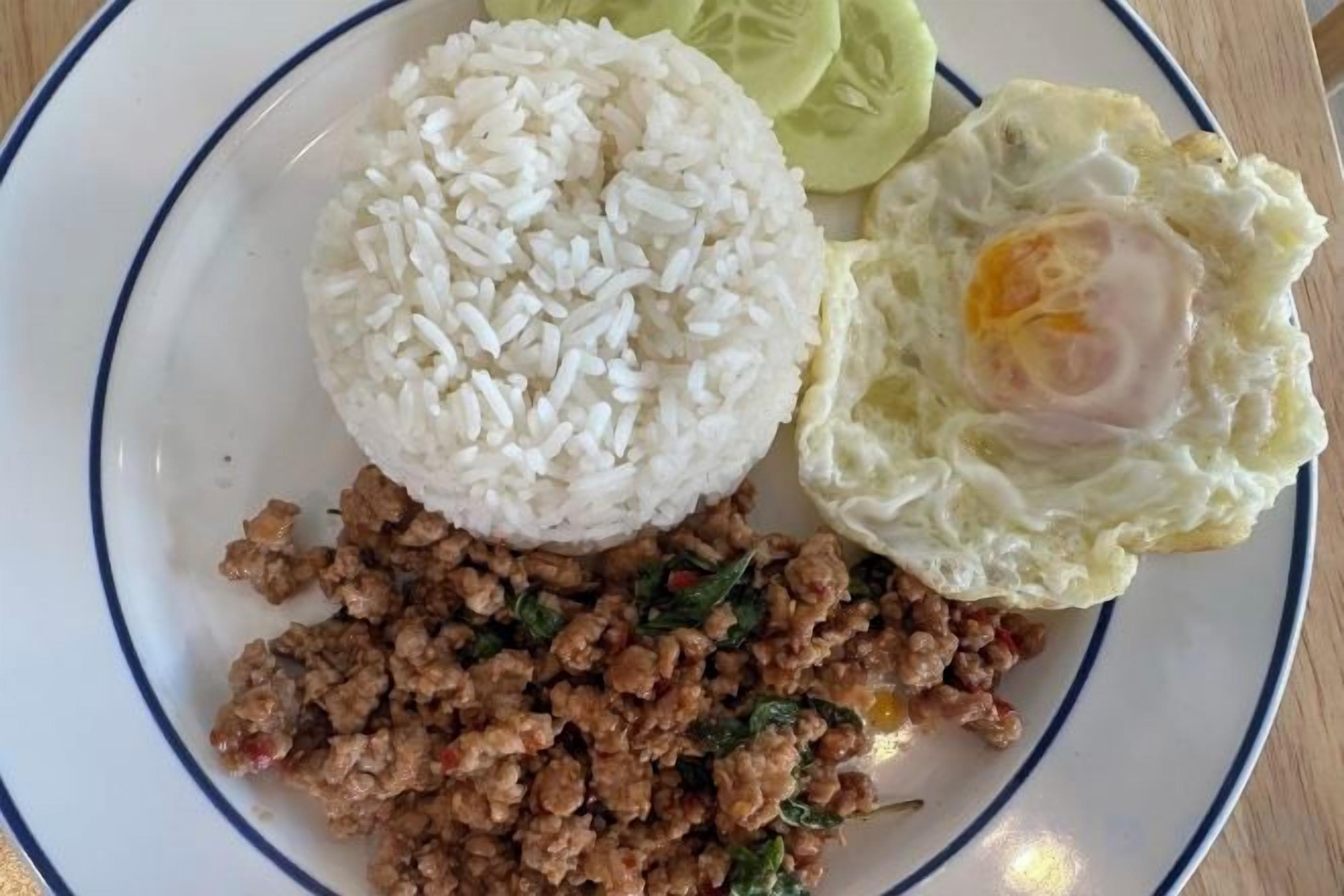 A plate with white rice, a fried egg, and minced meat.