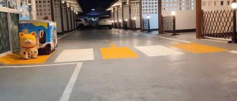 A corridor with directional arrows on the floor, a vending machine, and a security gate.