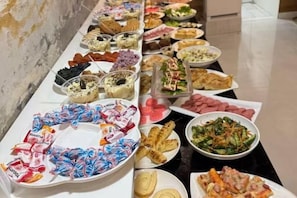 A buffet table with various dishes and snacks. - AERON Hotel (Tashkent)