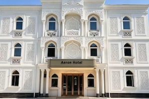 A multi-story building with a sign reading 'Aeron Hotel' at the entrance. - AERON Hotel (Tashkent)