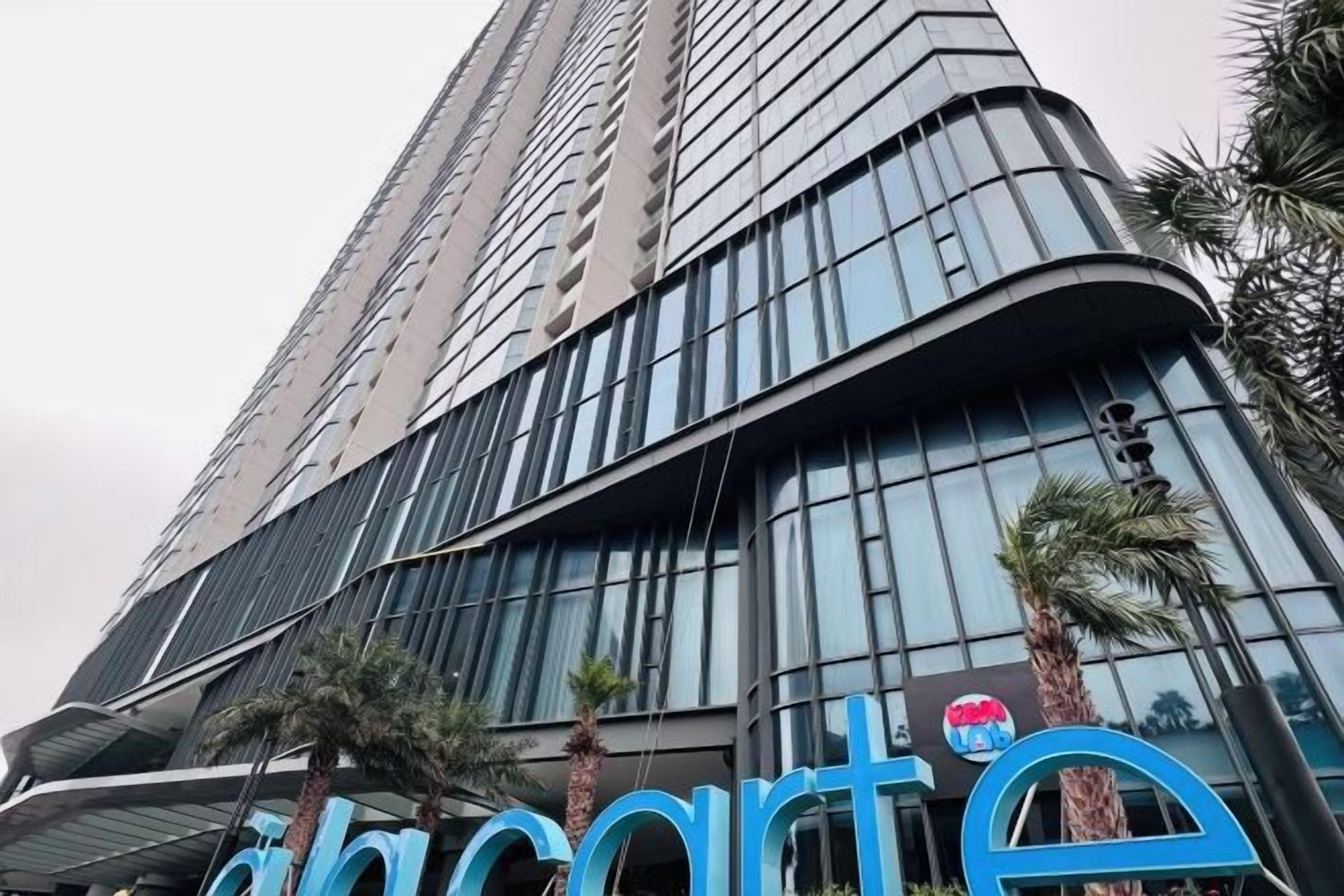 A high-rise building with a curved facade and large windows.