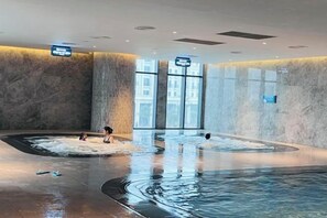 A large indoor swimming pool with two hot tubs and a central water feature. - A La Carte Ha Long Bay Apartments by Kevin & Anna (Ha Long)