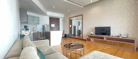 A modern living room with a sofa, coffee table, and entertainment unit.