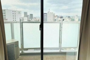 A view from a balcony with a cityscape in the background. - Rakuyado Sanno (Osaka)