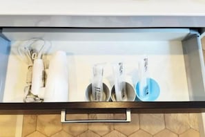 A drawer with a white towel, a white bottle, and a blue bottle. - Rakuyado Sanno (Osaka)