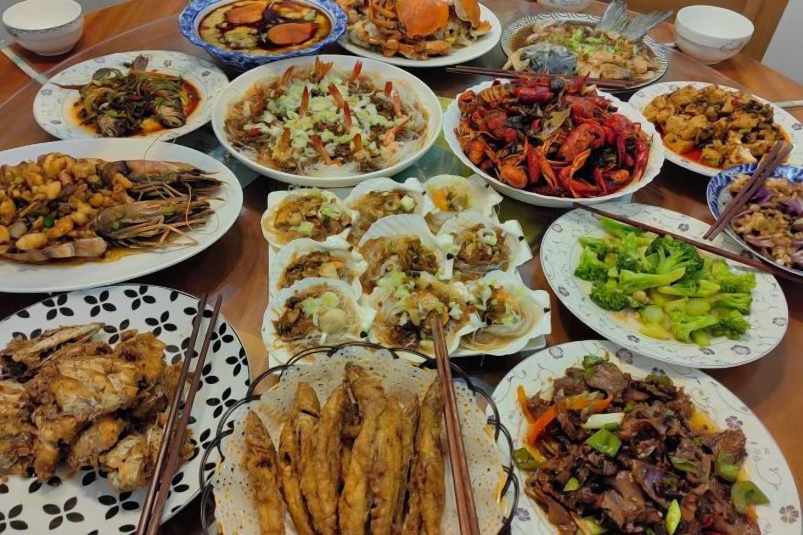A table with various dishes, including seafood and vegetables.