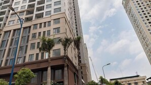 A tall, modern building with multiple floors and large windows. - Saigon Royal and Tresor apartments (Ho Chi Minh City)