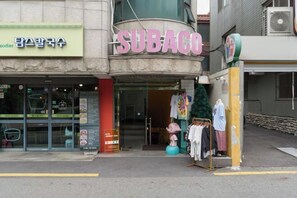A storefront with a sign reading "SUBACO" and another sign for "Taco Bell". - Seoul Yapee guesthouse /Hongik University Sta. .Big House.party room.Two Rooms. (Seoul)