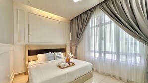 A hotel room with a large bed, a bedside table, a lamp, and a window with curtains. - Melaka Novo 8 Residence - Jonker Street by Stayrene (Melaka)