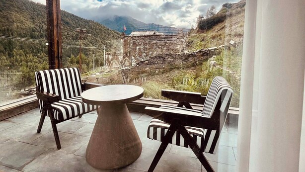 A terrace with a table and chairs, overlooking a mountainous landscape. - Mid Hill White Lodge (Ngawa Autonomous Prefecture)